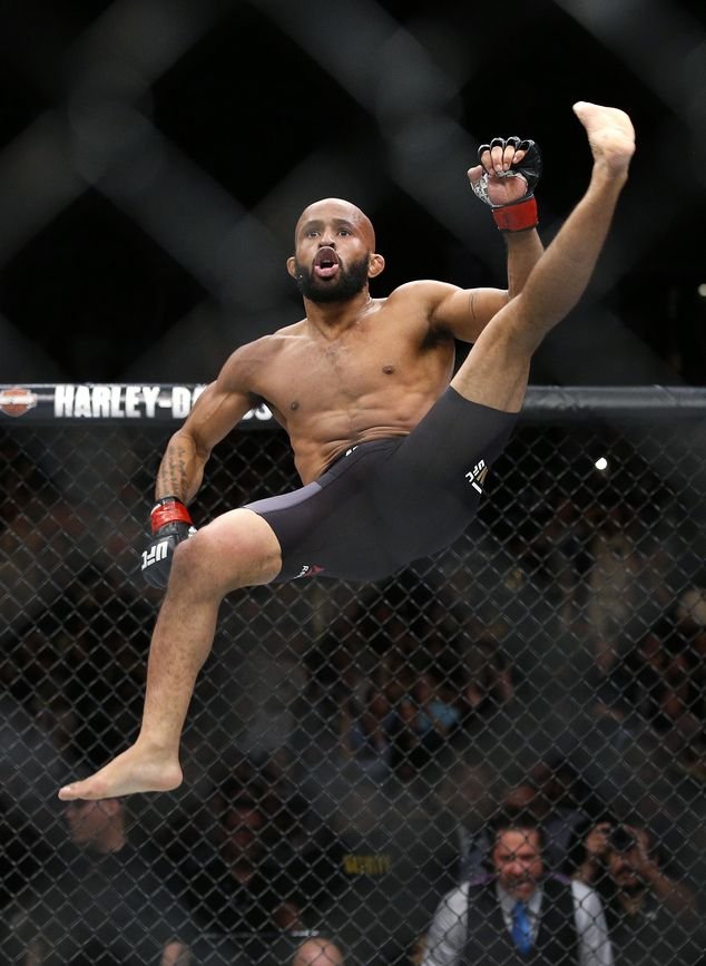 Demetrious Johnson celebrates after defeating Henry Cejudo in a flyweight championship mixed martial arts bout at UFC 197, Saturday, April 23, 2016, in Las Vegas. (AP Photo/John Locher)